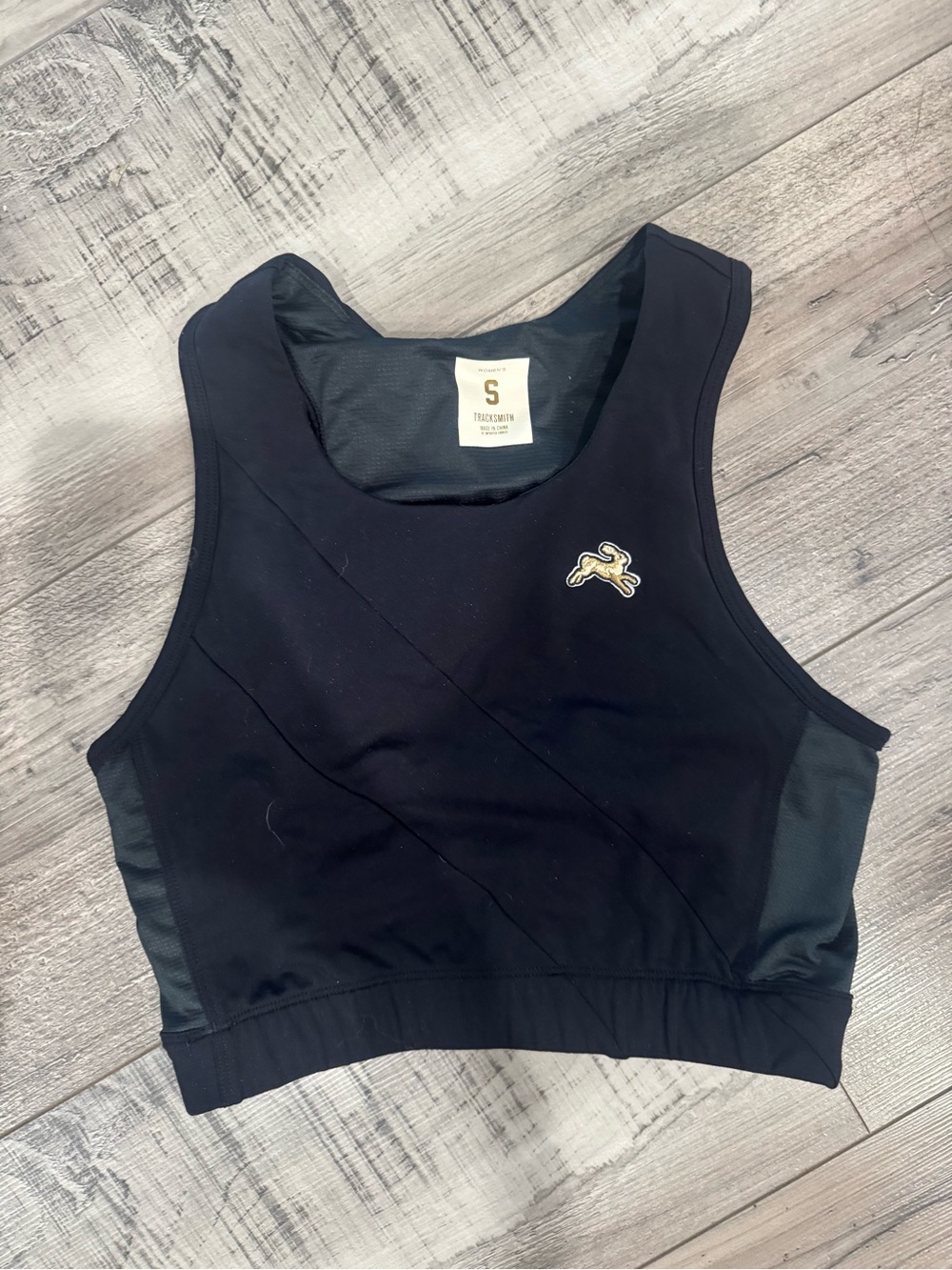 Tracksmith Black Cropped Sports Bra with Gold Hare Logo bell lap